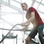 Man som tränar med rep i Gymmiljö.