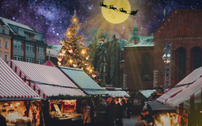 julmarknad med stjärnklar himmel, måne med tomtens släde framför.